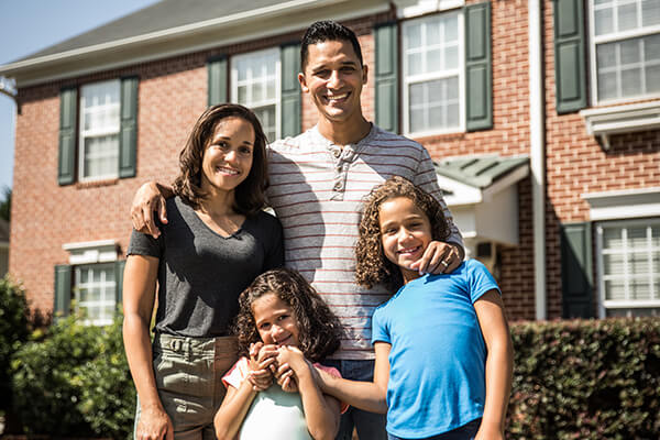 family in front of house